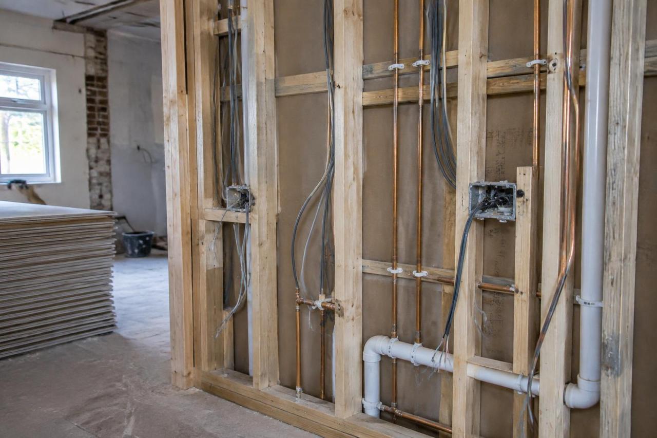 Illustrative image of first-fix plumbing and electrical work in a UK house renovation
